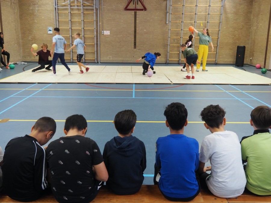 kids watching and performing sports activities