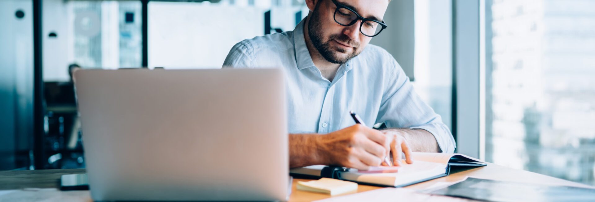 man working behind laptop